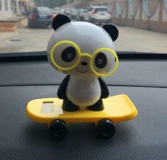 Solar car decoration panda with automatic head shaking skateboard