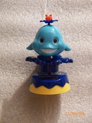 Solar Whale riding on wave with big smile decorative collectible classic