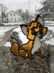This product is a handmade stained glass fox suncatcher 4 In