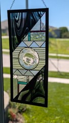 IRIDESCENT STAINED GLASS PANEL BY “SKIP SCHIPPER” 24″T x 10.5″ W. SIGNED