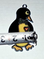 1980s vintage penguin suncatcher features a yellow glitter belly and a red heart