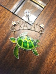 This item is a decorative stained glass sea turtle suncatcher, From Kauai